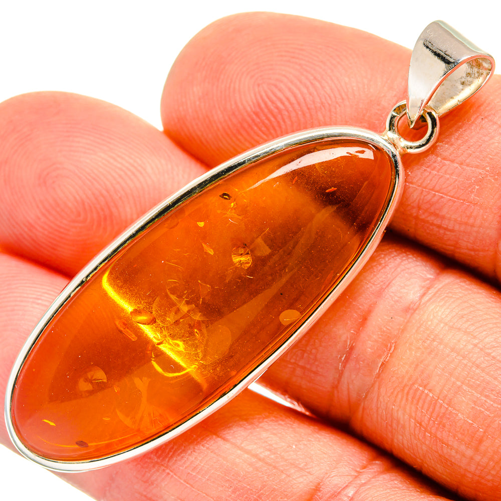 925 sterling silver teardrop pendant with orange Baltic amber, small top loop bail