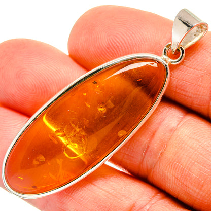 925 sterling silver teardrop pendant with orange Baltic amber, small top loop bail