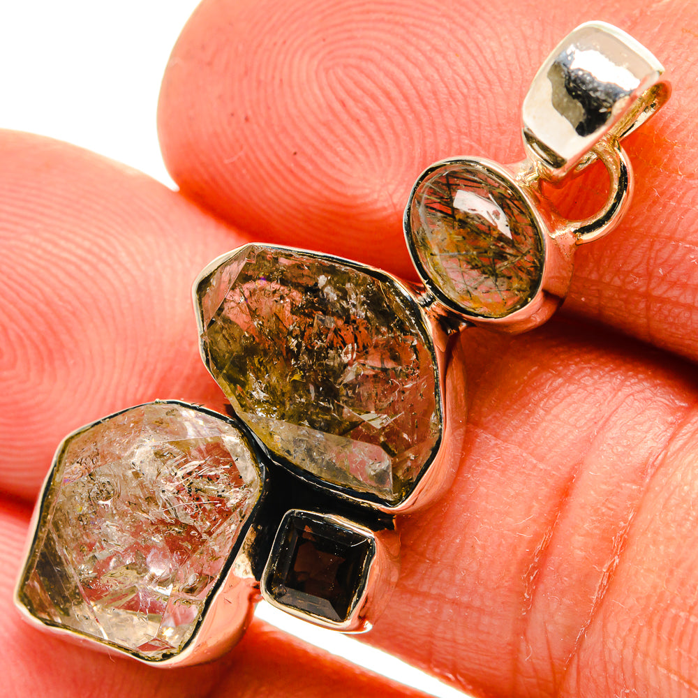 Faceted tourmalinated and smoky quartz pendant with 925 sterling silver bezel, close-up