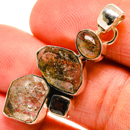 Faceted tourmalinated and smoky quartz pendant with 925 sterling silver bezel, close-up