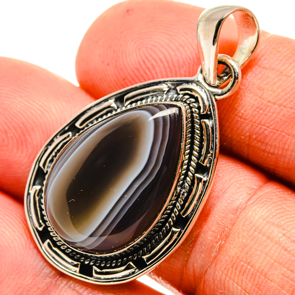 Sterling silver Botswana agate pendant with dark striped cabochon stone in an oval setting