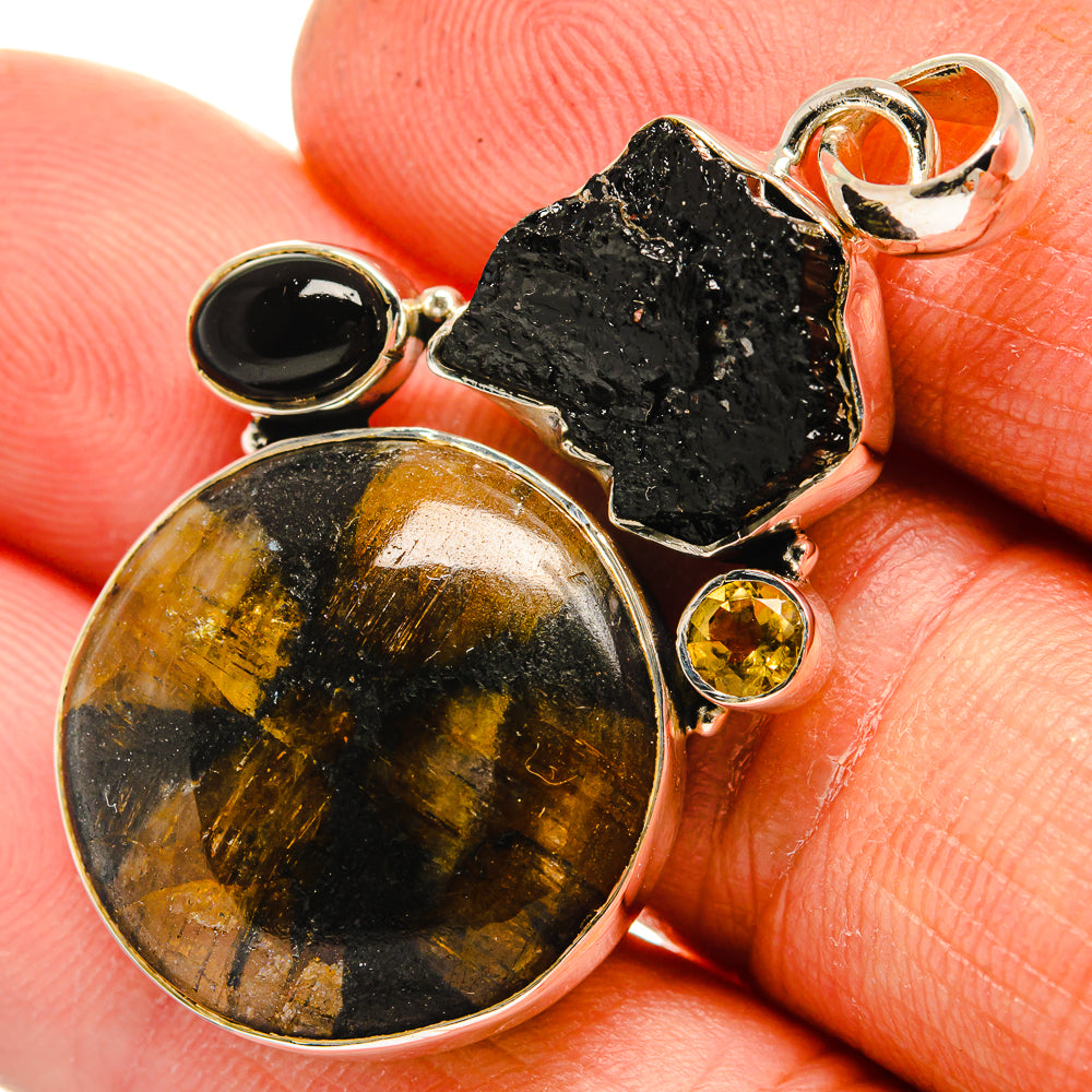 Sterling silver pendant with round black onyx, rough black stone, and gold citrine accents