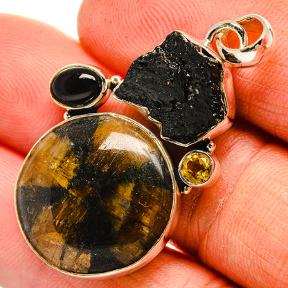 Sterling silver pendant with round black onyx, rough black stone, and gold citrine accents