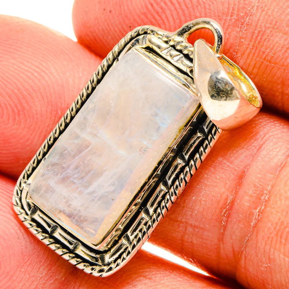 Rectangular moonstone pendant close-up, sterling silver bezel with embossed border and bail