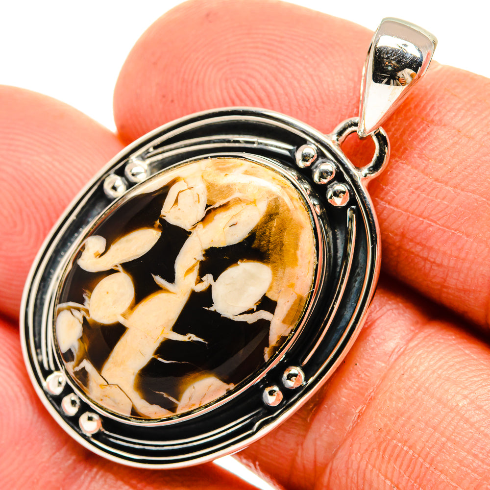 Oval sterling silver pendant with amber-brown jasper and leaf-like pattern