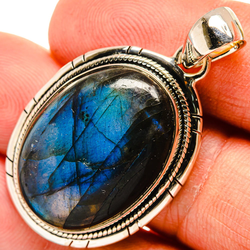 Oval labradorite pendant with blue flash, bezel-set in antique silver frame