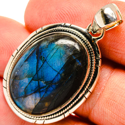 Oval labradorite pendant with blue flash, bezel-set in antique silver frame