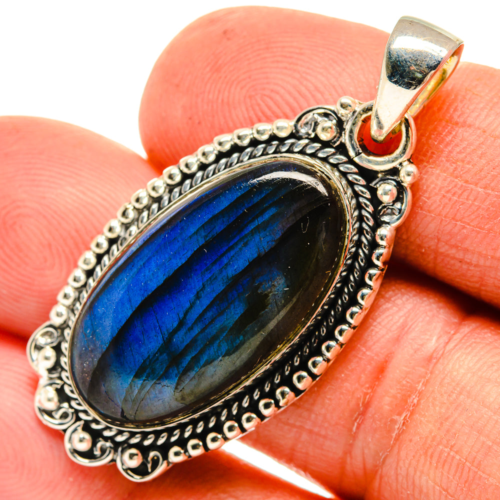 Oval labradorite pendant with blue sheen, detailed sterling silver bezel and bail