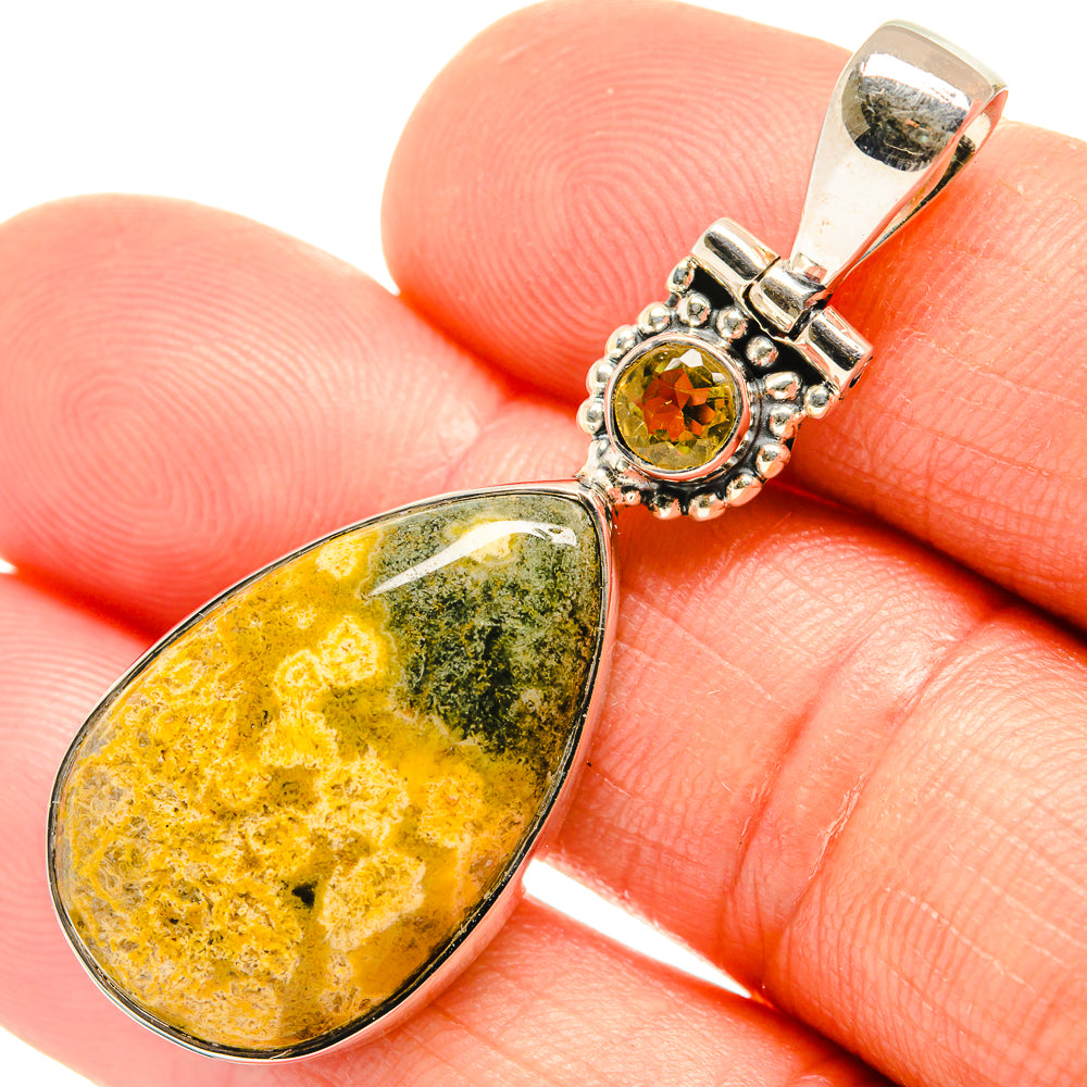 Close-up sterling silver pendant: teardrop ocean jasper with round citrine top setting