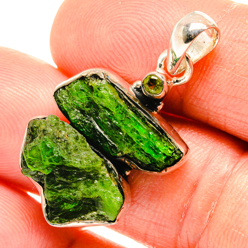Sterling silver pendant detail with rough green stones and small round peridot