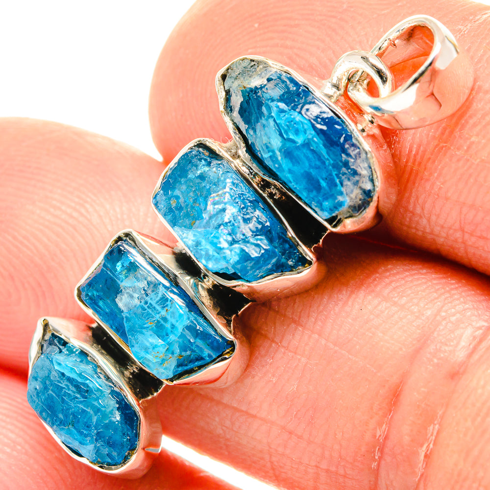 Close-up rough apatite pendant, 925 sterling silver setting with blue rough stones