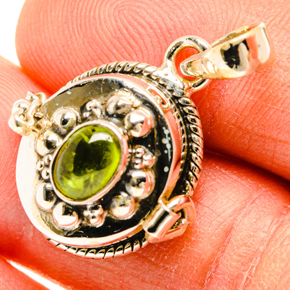 Sterling silver round halo pendant with bright green oval gemstone and bail.