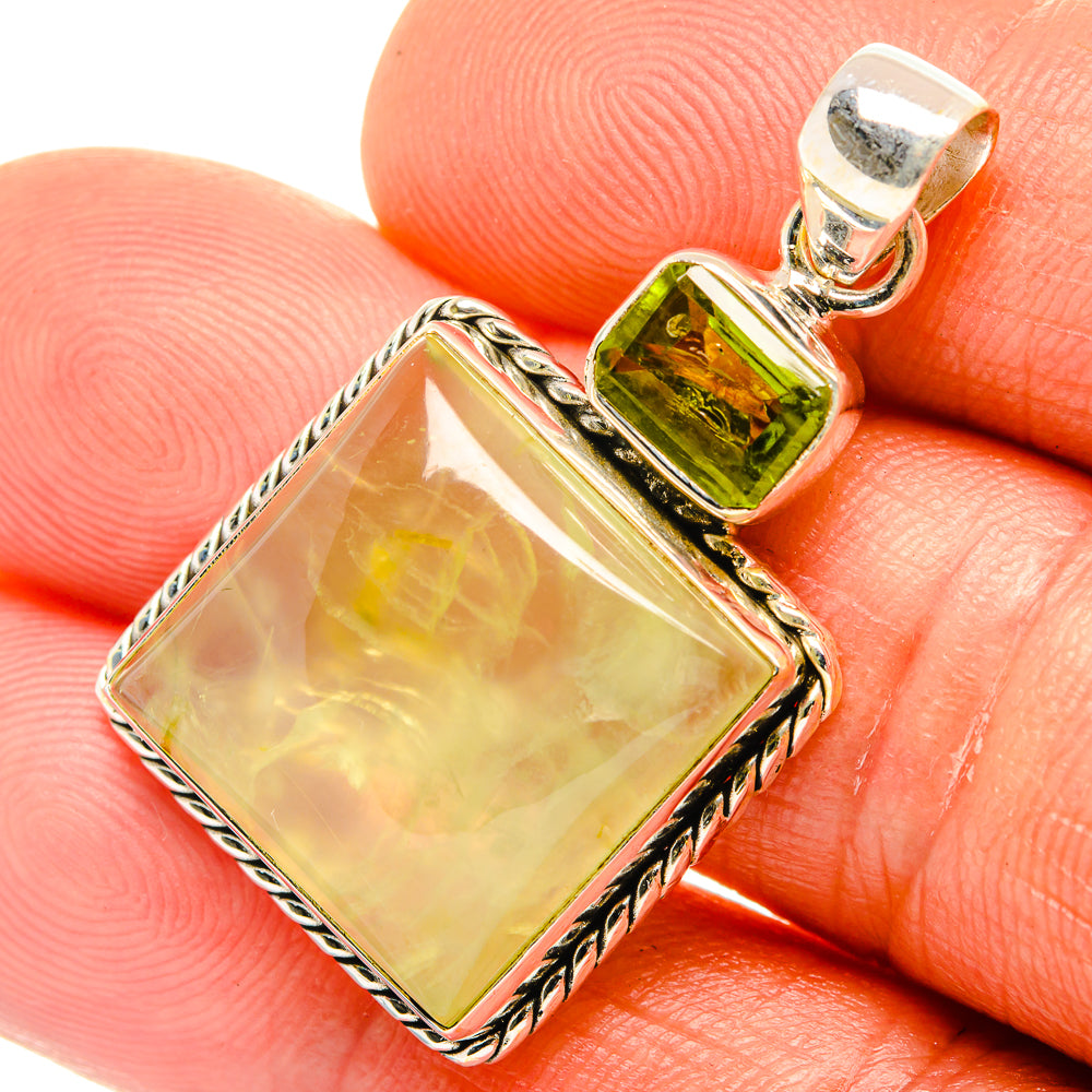 Square pale yellow stone pendant with green peridot bezel and rope-edge silver frame