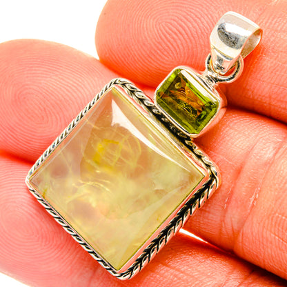 Square pale yellow stone pendant with green peridot bezel and rope-edge silver frame