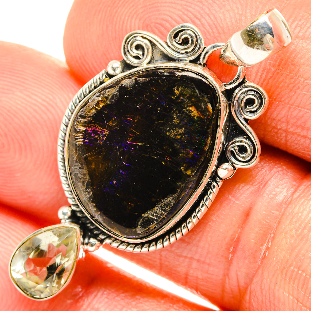 Sterling silver ammolite pendant with iridescent black center and ornate bail
