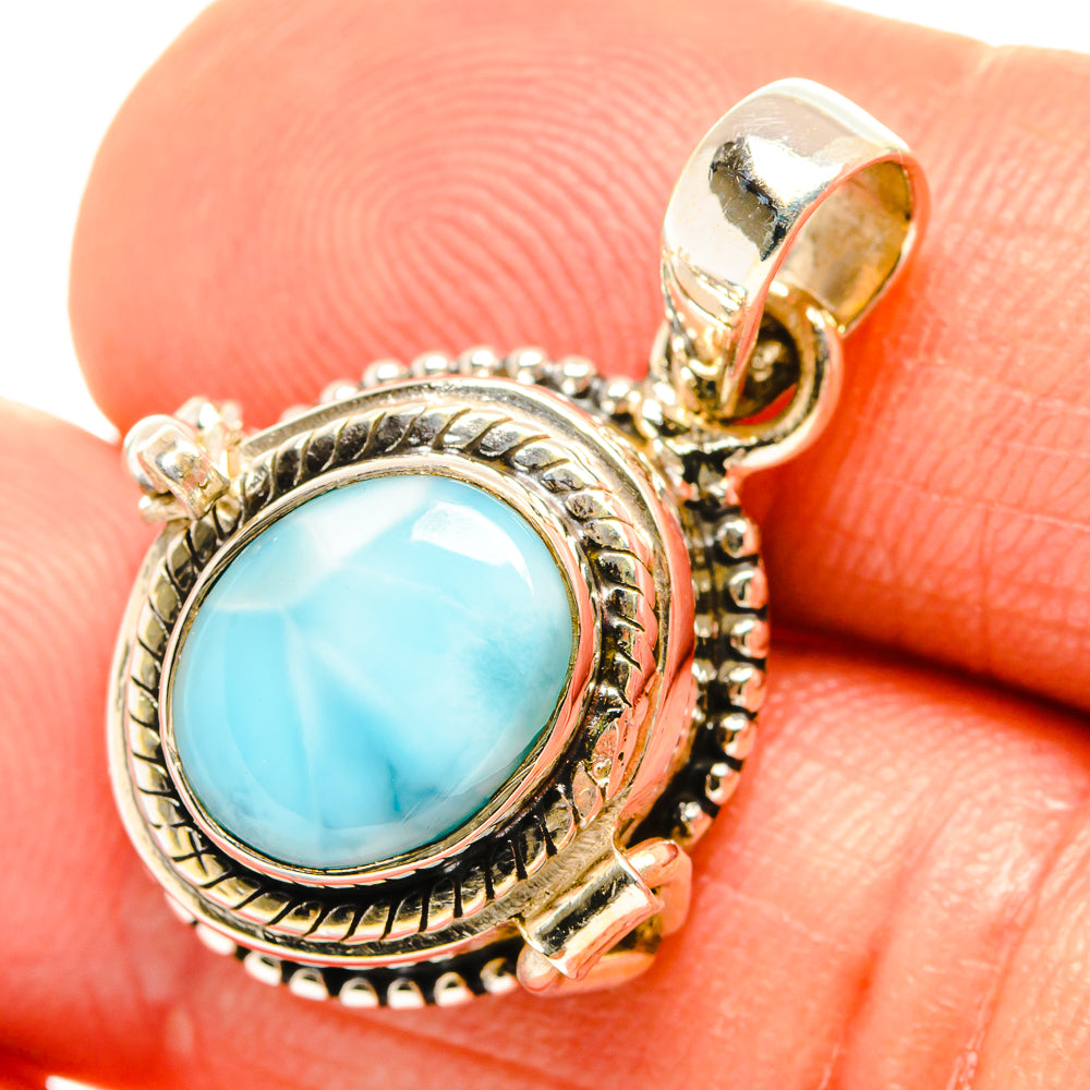 Sterling silver larimar pendant close-up, oval light-blue stone in detailed textured setting