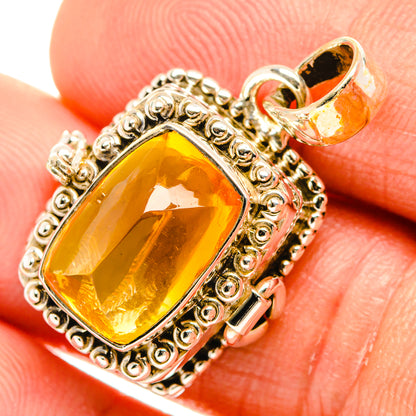 Orange citrine pendant with detailed silver border and looping bail