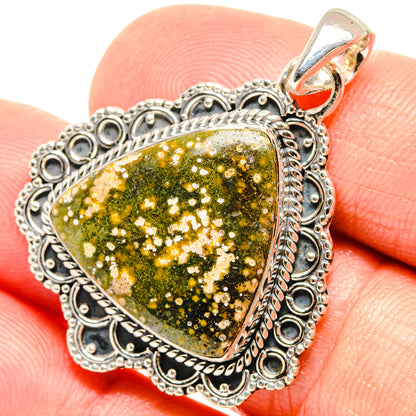 Ocean jasper heart pendant close-up, green-gold speckled stone in ornate 925 sterling frame