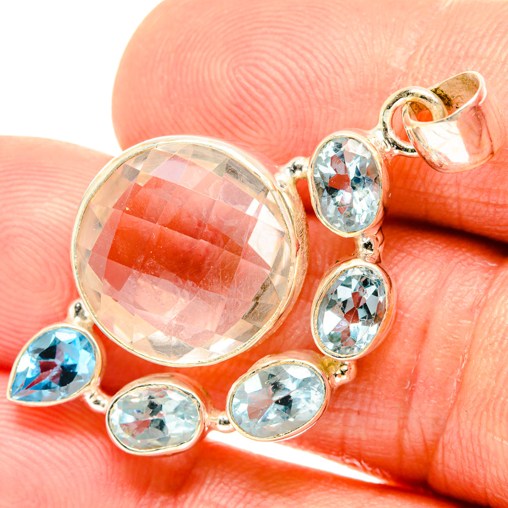 Sterling silver pendant with large oval white quartz and blue topaz accents, prong-set
