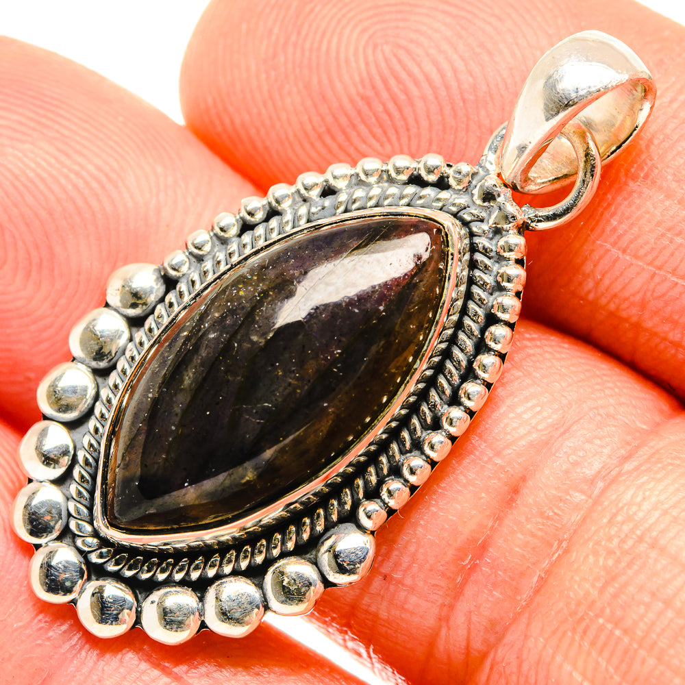 Oval labradorite pendant with dark stone, silver bead halo, ornate bezel and bail