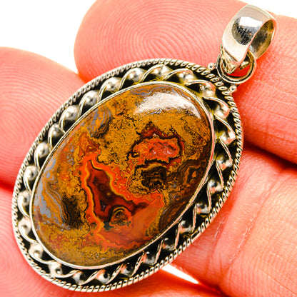 Close-up oval agate pendant with 925 sterling silver ornate frame and top bail