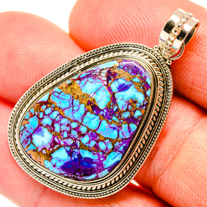 Teardrop turquoise pendant in purple-blue stone with ornate silver frame and bail
