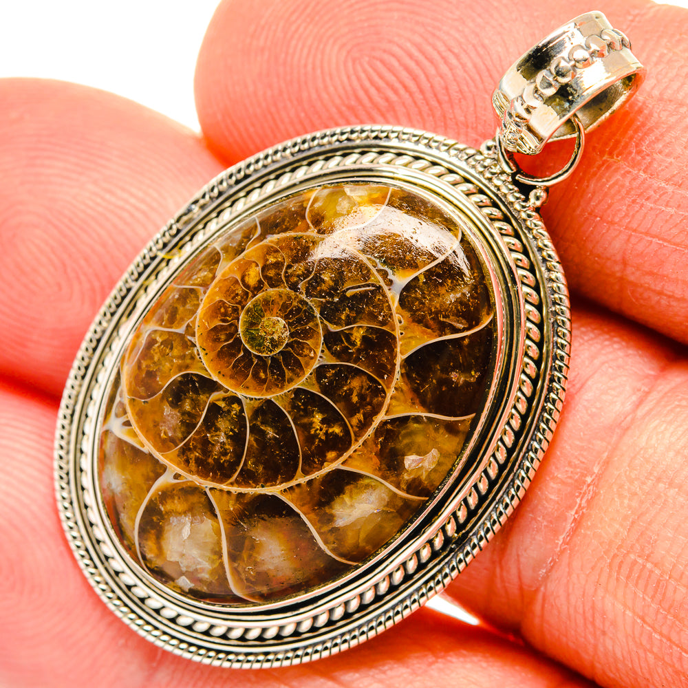 Ammonite fossil pendant in oval 925 sterling silver frame, amber-brown stone with pattern