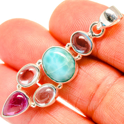 Multi-stone sterling silver pendant close-up with turquoise oval, blue and purple bezel-set stones