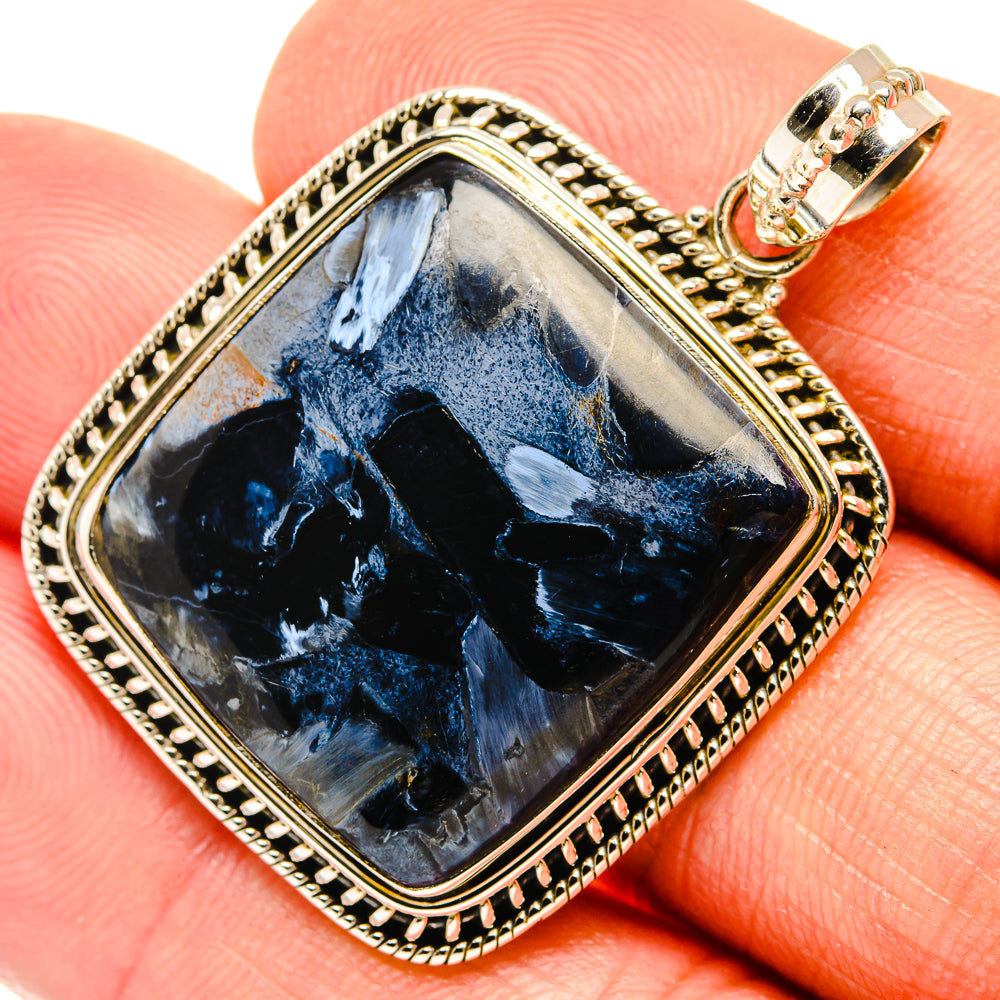 Square blue pietersite pendant with ornate gold-tone bezel and sterling silver bail