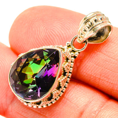 Sterling silver mystic topaz pendant close-up, faceted rainbow-toned teardrop stone in filigree