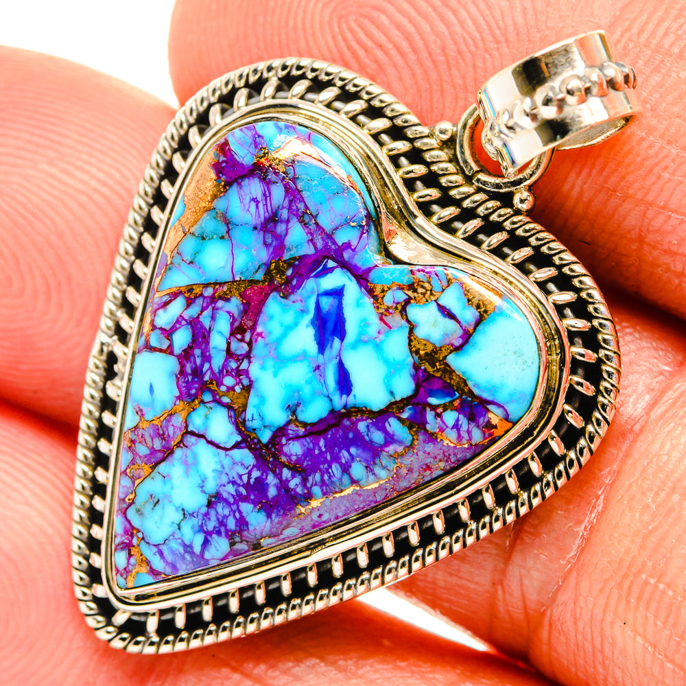 Heart turquoise pendant close-up with purple-blue stone bezel and textured silver edging