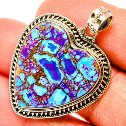 Turquoise inlay heart pendant with gold-tone accents and textured silver-tone frame