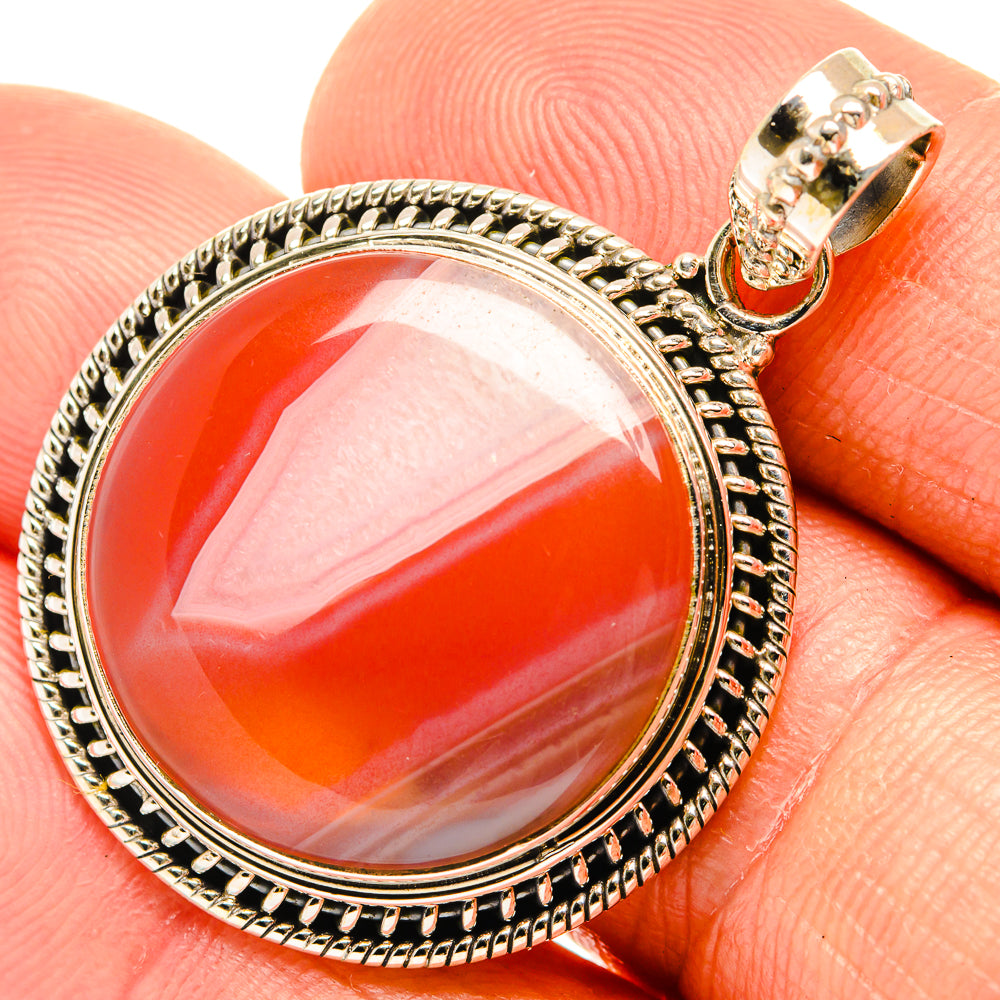 Round red agate pendant in 925 sterling silver bezel with ornate textured border