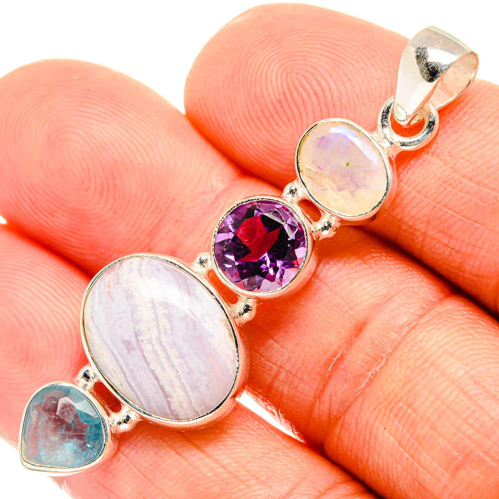 Sterling silver gemstone pendant close-up: purple round stone, pale oval moonstone, blue teardrop