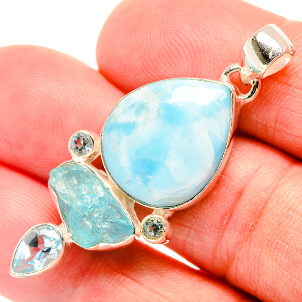Sterling silver pendant with large light-blue teardrop center stone and small round accents