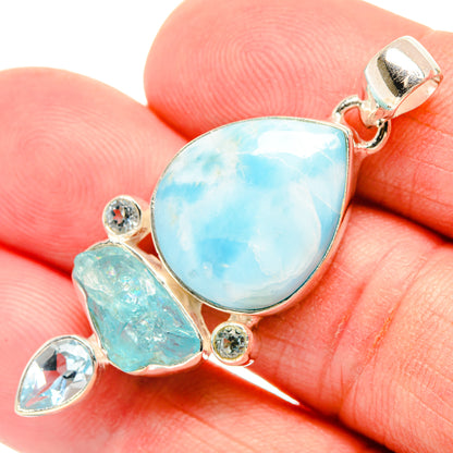 Sterling silver pendant with large light-blue teardrop center stone and small round accents