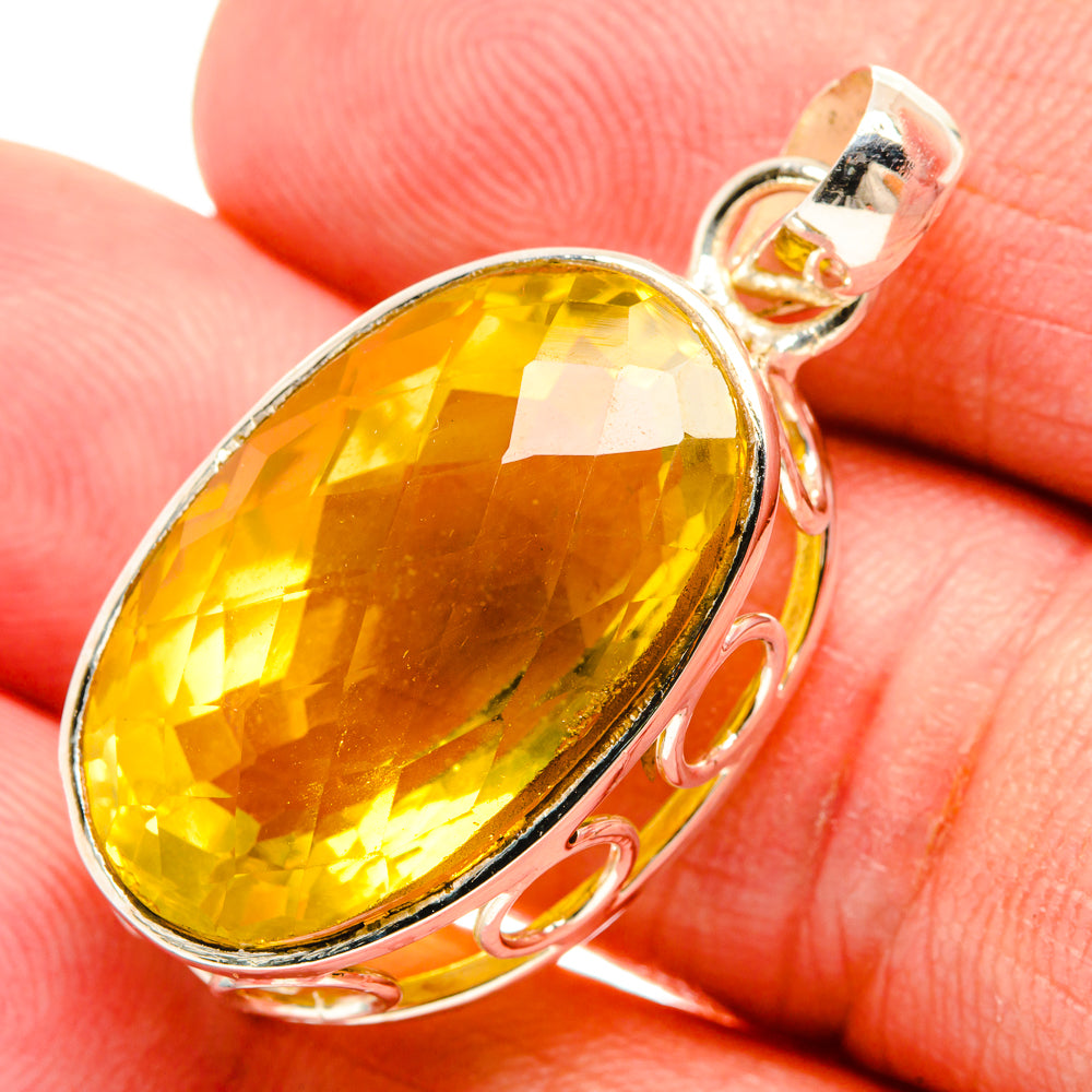 Oval yellow quartz pendant in sterling silver bezel with loop bail