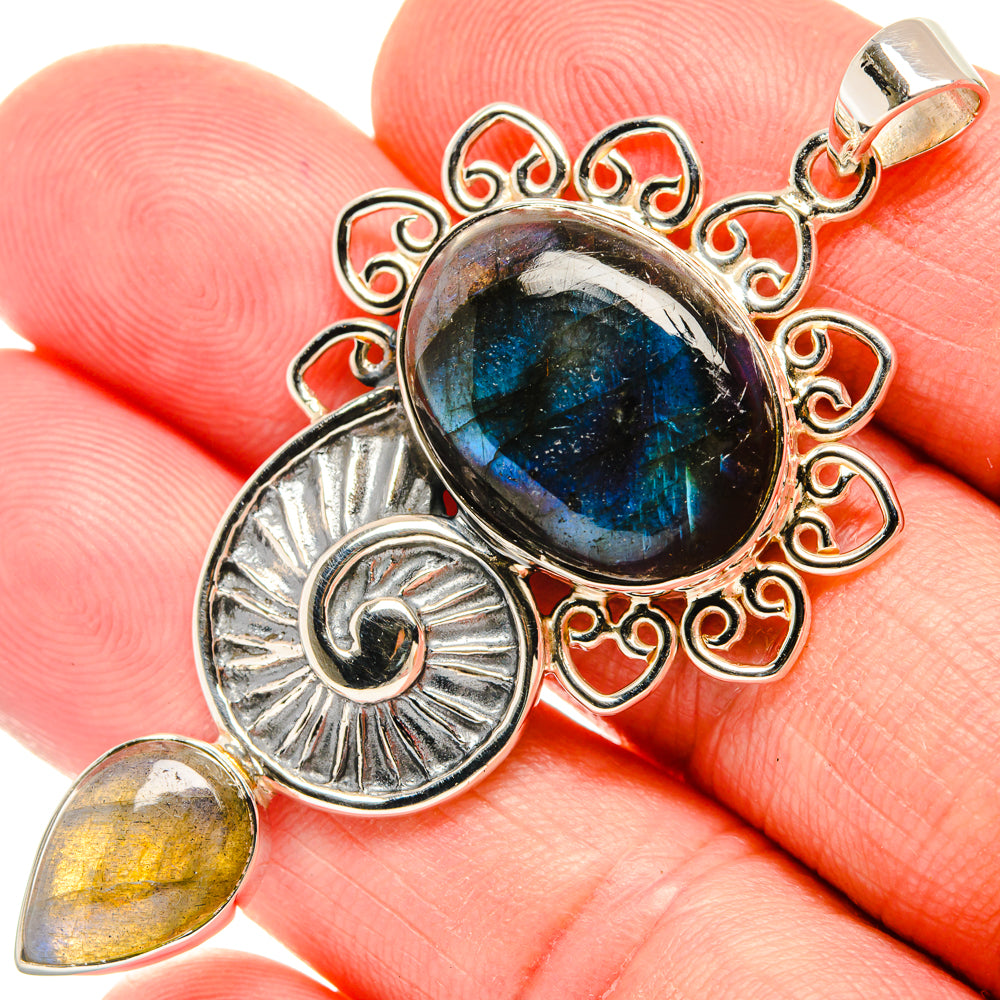 Sterling silver labradorite pendant with oval blue iridescent gemstone and swirl filigree
