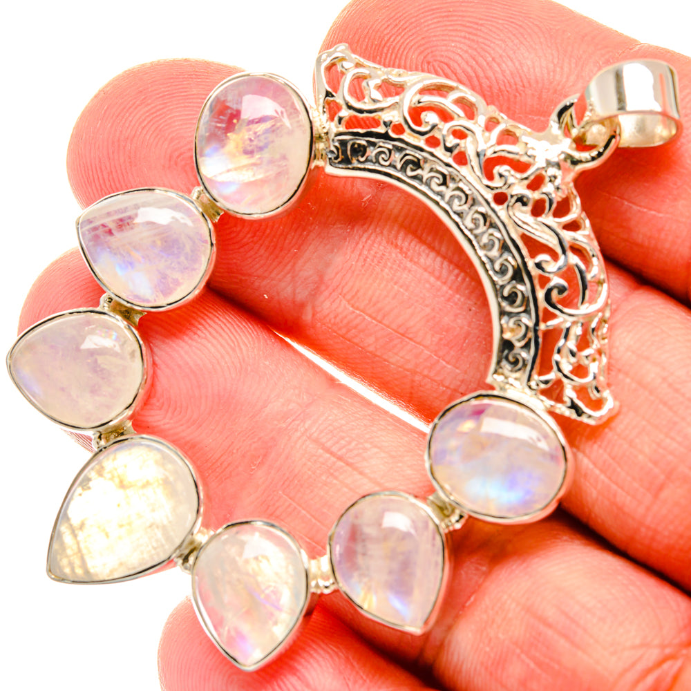 Rainbow moonstone pendant close-up with teardrop opal stones and silver filigree setting