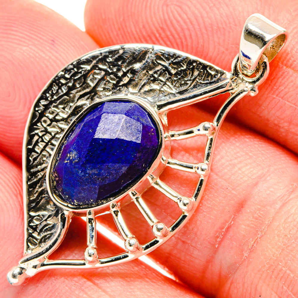 Close-up lapis lazuli pendant: oval blue stone in silver bezel with fan prong accents