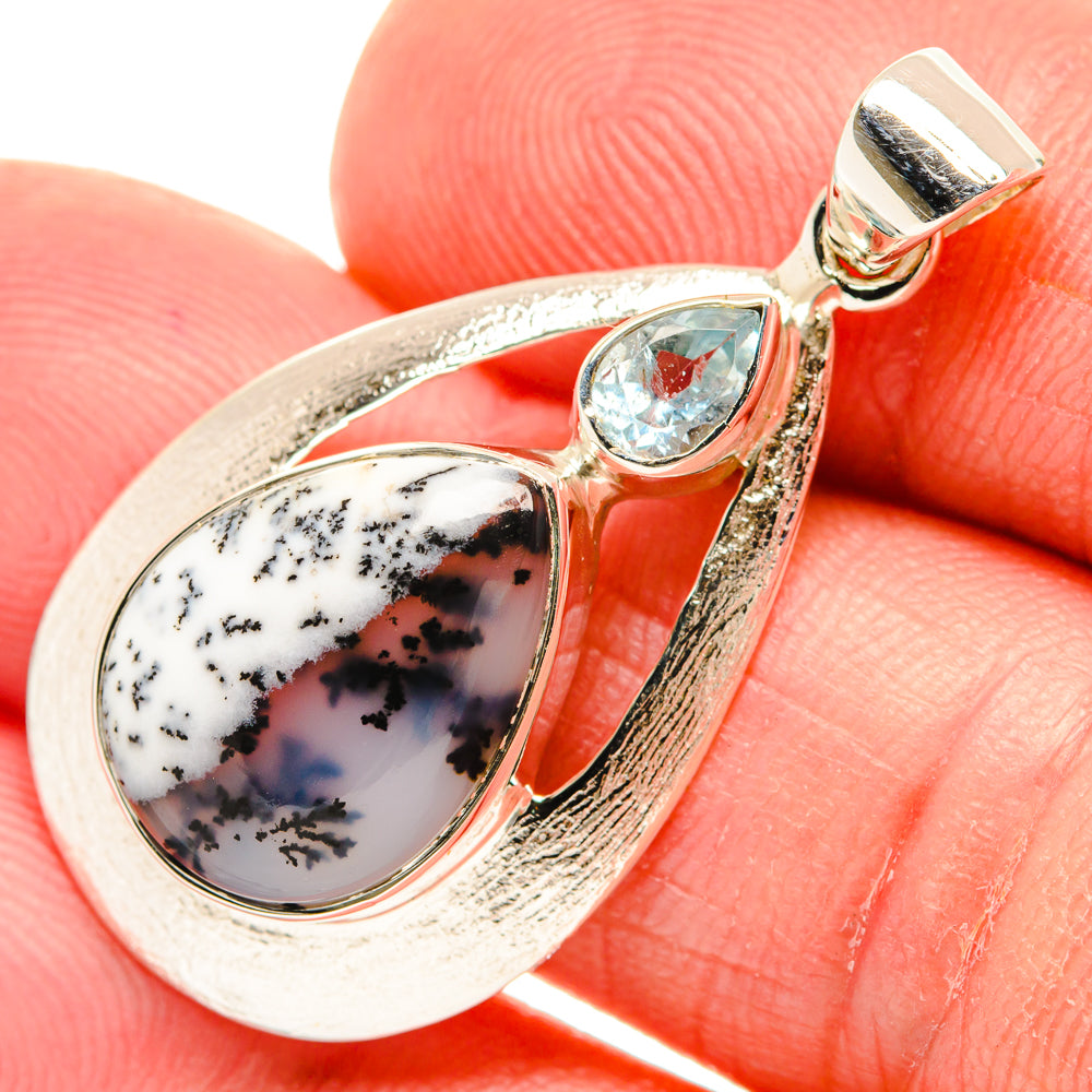 Oval dendritic opal pendant in 925 sterling silver with blue topaz center stone