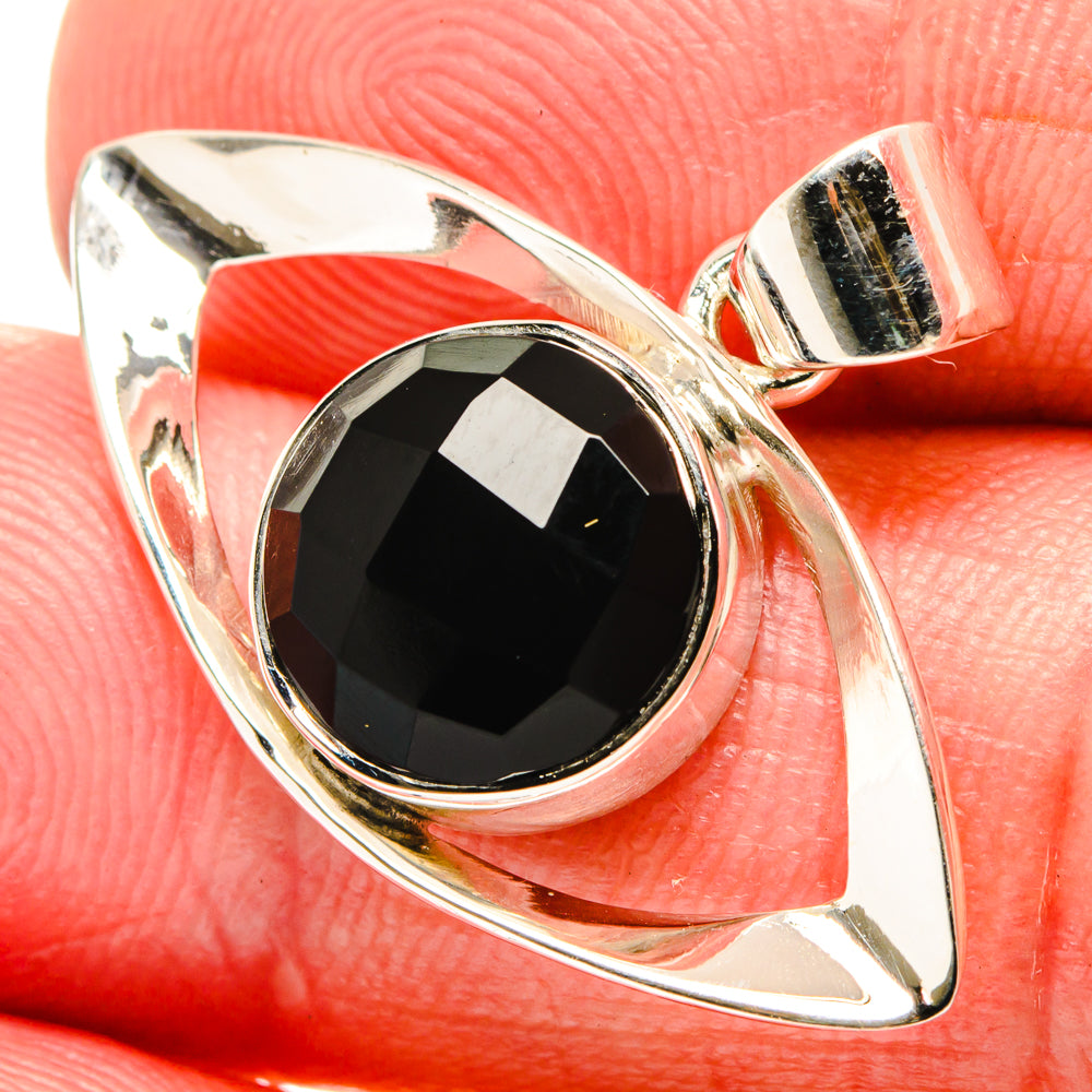 Silver pendant with oval faceted black onyx in open geometric bezel setting