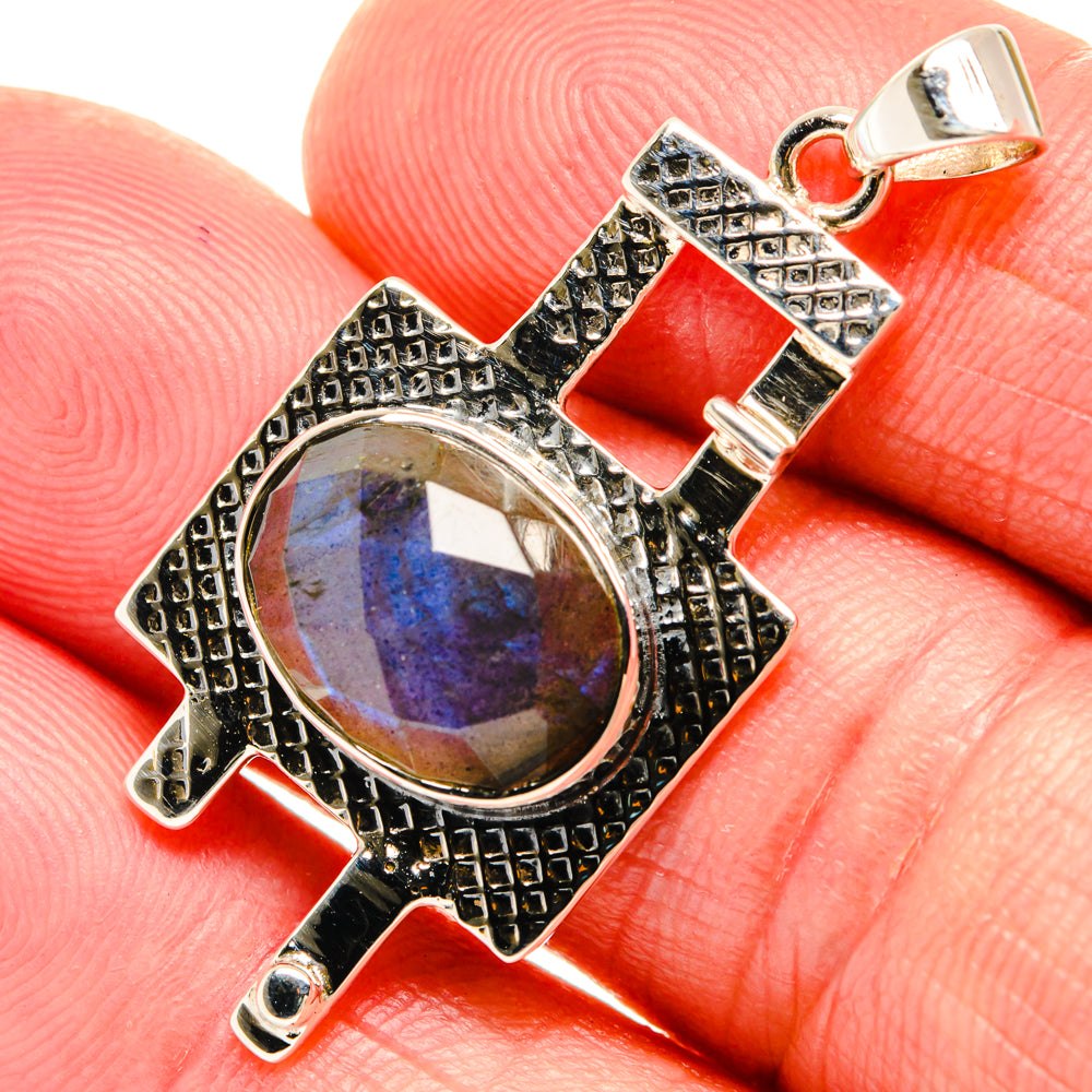 Labradorite pendant close-up: oval stone with blue shimmer in vintage silver frame