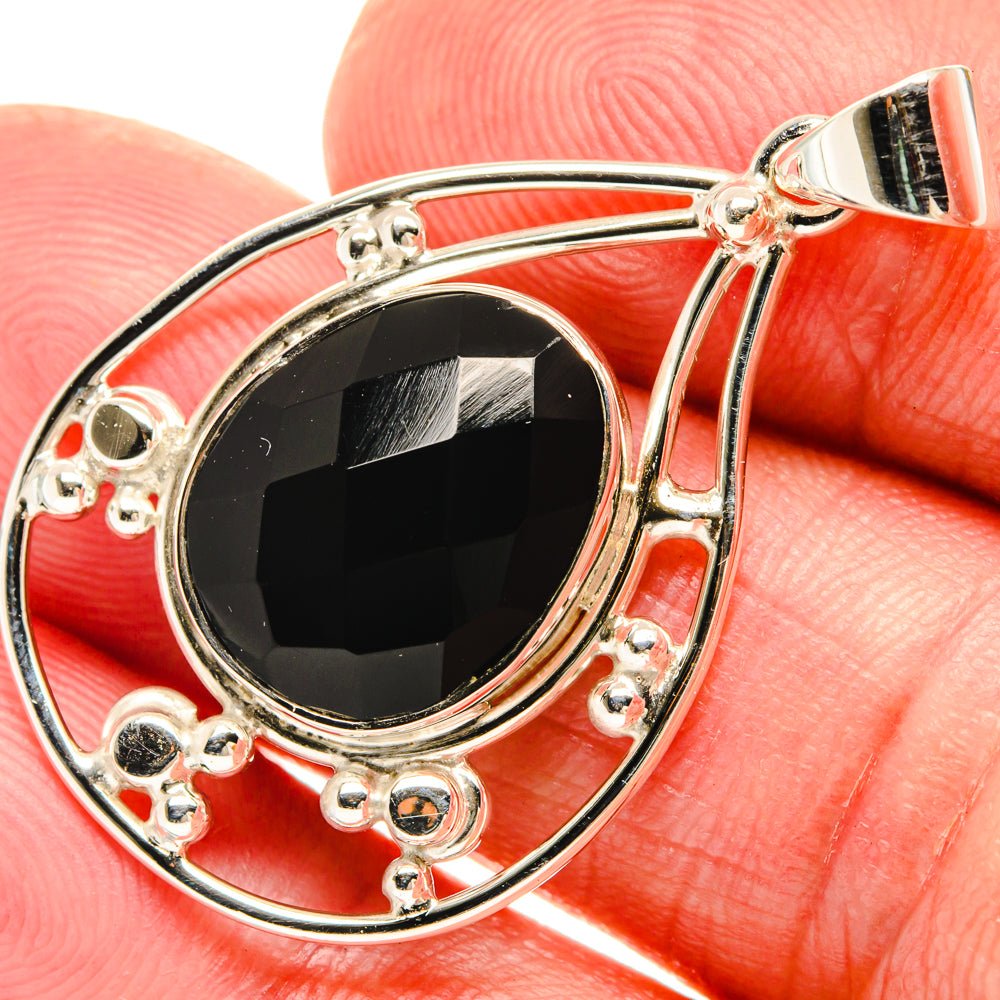 Black onyx teardrop pendant in 925 sterling silver with textured bezel and bail