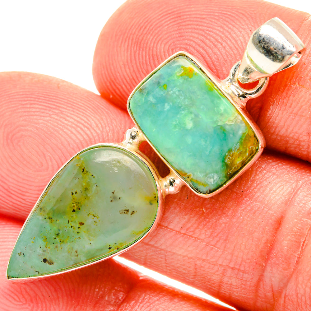 Two-stone pendant with silver bezel settings and green faceted cabochons, teardrop and square.