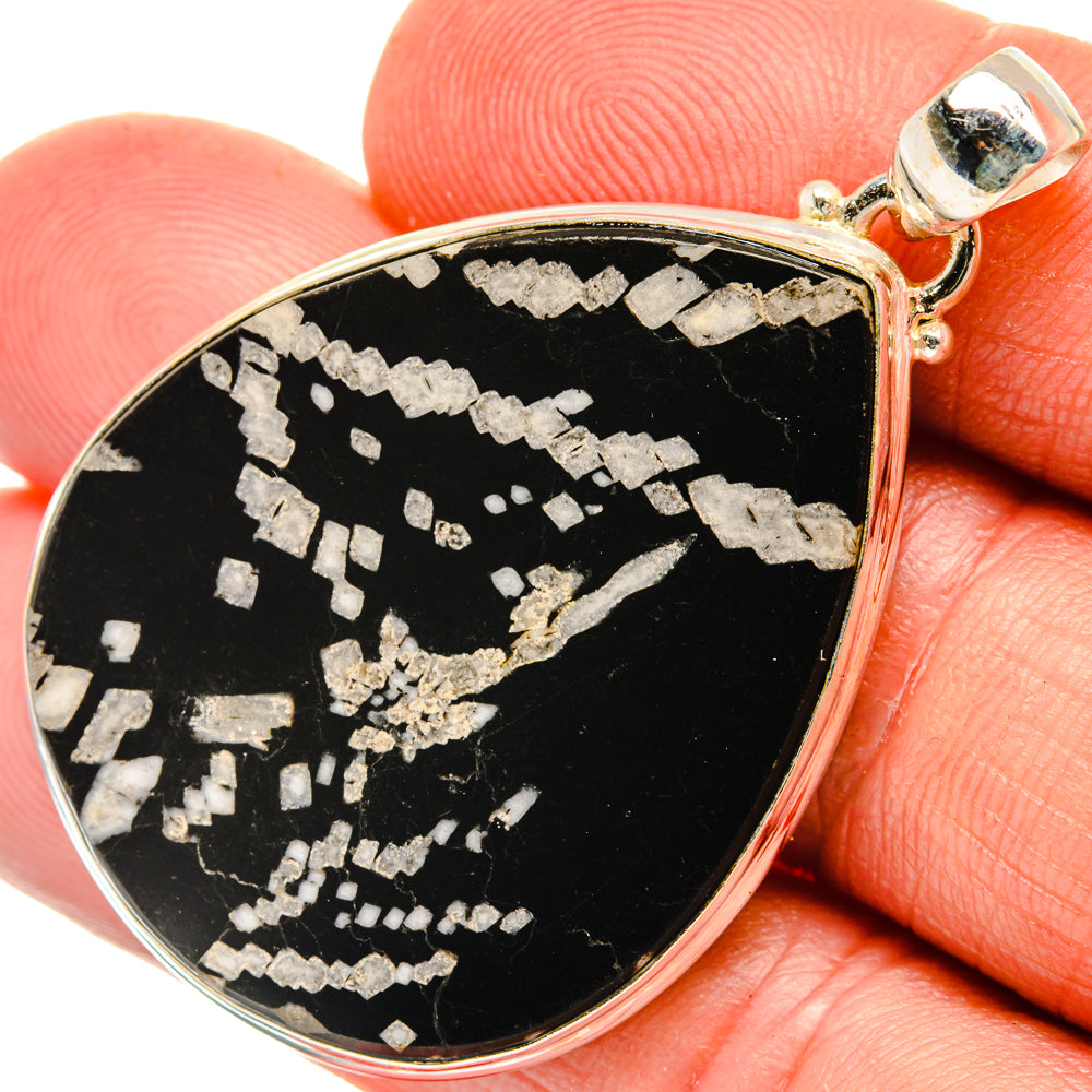 Chrysanthemum stone pendant, black teardrop with white floral mosaic, sterling bail