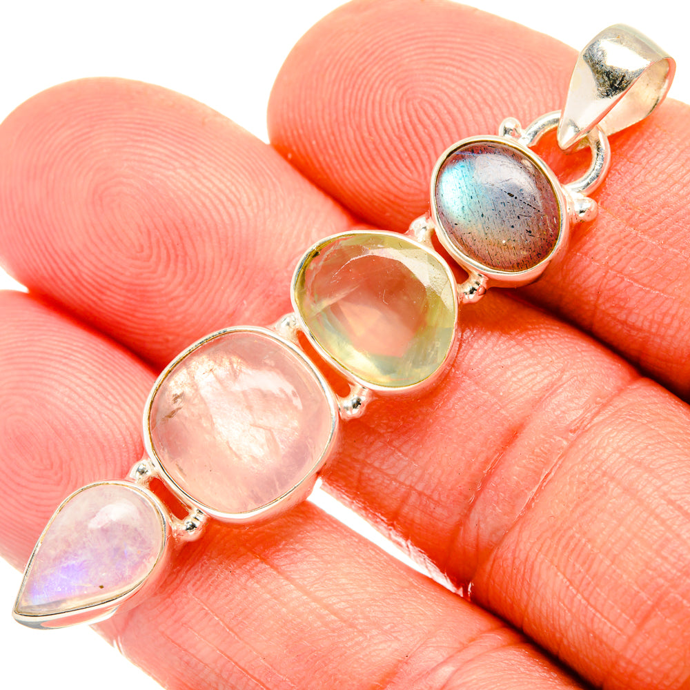 Sterling silver pendant with bezel-set pink, green, and blue stones; top bail shown