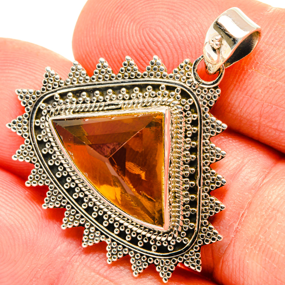 Sterling silver citrine sugarloaf pendant with triangular orange-yellow gemstone, beaded frame and spiked border