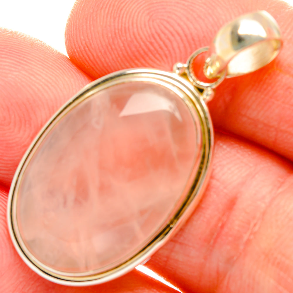 Rose quartz oval pendant with polished silver frame and small bail loop