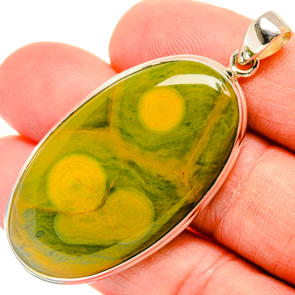 Oval green ocean jasper cabochon pendant with sterling silver bezel and gold-tone bail